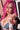 Sex doll with pink hair and denim outfit in a blurred indoor setting