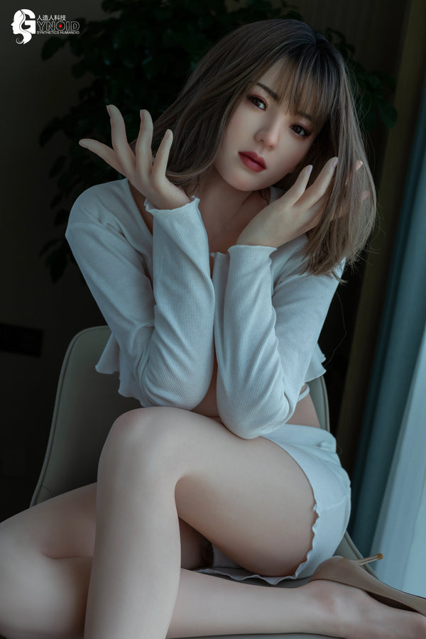 Woman in a white outfit sitting on a chair with a blurred background