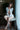 Woman sitting on a chair wearing a revealing outfit with a blurred background