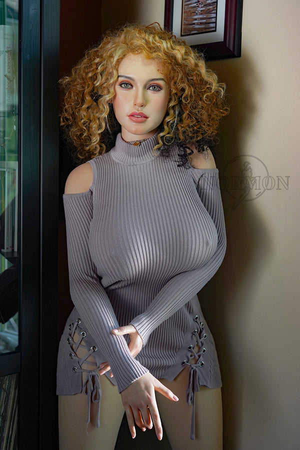 Mannequin wearing a gray ribbed sweater with cut-out details in a room setting.