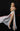 Woman in a white dress with a high slit on a black background