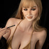A highly realistic sex doll with blonde hair and a golden tank top, posed sitting with a cigarette in her hand.