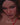 Video of woman wearing a red crochet outfit on a black background
