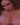 Video of woman wearing a red crochet outfit on a black background